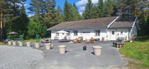 a house with a lot of trash cans in front of it at Telemark Motel in Hauggrend
