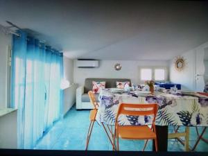 a dining room with a table and two chairs at Casa Blu with Sea View - Borgo Stays in Sperlonga