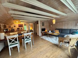a living room with a couch and a table and chairs at Bard Cottage in Akranes