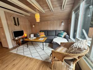 a living room with a couch and a table at Bard Cottage in Akranes