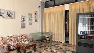 a living room with a table and a couch and a table at Hotel Ambassador Room Only - Self Check-in in Cattolica