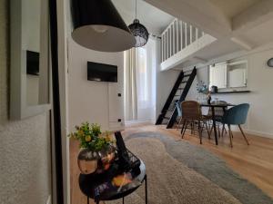 a living room with a table and a dining room at Menton centre Cosy and spacious in Menton