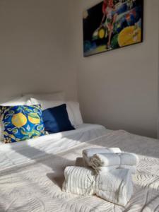 a bed with two towels on top of it at Menton centre Cosy and spacious in Menton +23 photos