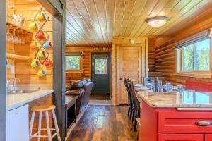 a kitchen and dining room with a bar in a log cabin at Blue Spruce Cabin in West Yellowstone