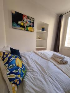 a bedroom with a bed with two towels on it at Menton centre Cosy and spacious in Menton