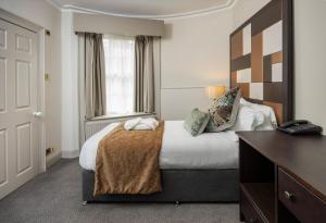 a hotel room with a bed and a desk at Albany Hotel in Edinburgh