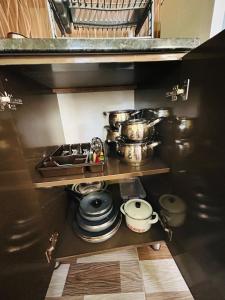 a kitchen with a sink and some pots and pans at Green Cottage in Ureki