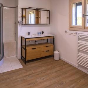 a bathroom with a sink and a mirror at Au petit bonheur in Hautefage-la-Tour