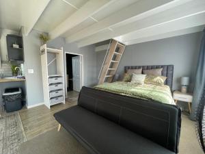 a bedroom with a bed and bunk beds in it at ACORN STUDIO Fully equipped Studio with kids loft in Durban