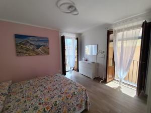 a bedroom with a bed and a large window at Casa Amarena in Sulmona