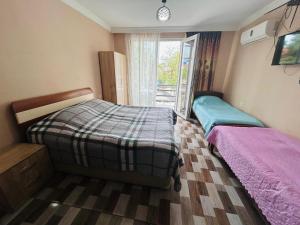 a bedroom with two beds and a window at Green Cottage in Ureki
