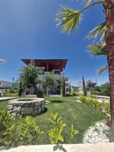 a view of a house with a palm tree at Velder House Urla in Urla