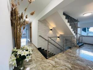 una escalera en una casa con flores en un jarrón en pokoje rojal, en Krynica Morska