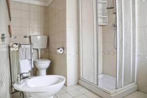 un bagno con wc e doccia in vetro di Parcheggio gratuito vicino alla Torre di Pisa a Pisa