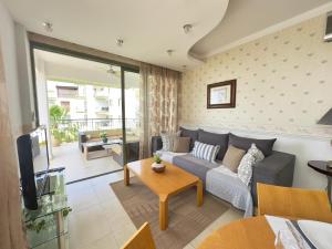 a living room with a couch and a tv at Near the sea Danaos 2 nice 2bd, 2bath sea view in Paphos City
