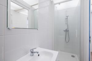 a white bathroom with a shower and a sink at Studio tout équipé proche centre ville & gare in Amiens