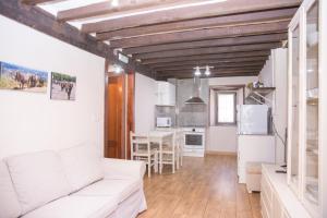 a living room with a white couch and a table at Casa rural La Bárcena Saja in Saja +22 photos