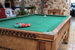 a pool table with balls on top of it at Hotel Serra Negra in Betim