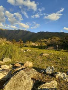 a field of rocks with mountains in the background at Nuevo Hotel Villa Giardino in Villa Giardino