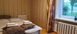 a bedroom with two beds with towels on top of them at Old Town apartment in Narva
