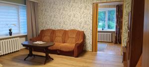 a living room with a chair and a table at Old Town apartment in Narva