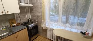 a kitchen with a window and a sink and a stove at Old Town apartment in Narva