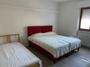 a bedroom with two beds and a window at La Magione in Fano