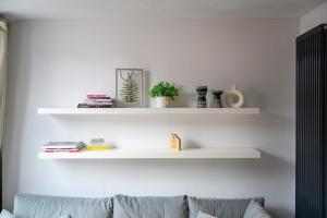 a living room with white shelves on the wall at Stunning Luxury Townhouse in Centre of Manchester in Manchester