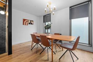 a dining room with a wooden table and chairs at Stunning Luxury Townhouse in Centre of Manchester in Manchester