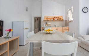 a kitchen with a table with a bowl of fruit on it at 2 Bedroom Nice Apartment In Jakisnica in Jakišnica