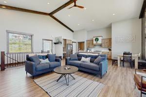 a living room with two blue couches and a table at The Big Blue in Garden City