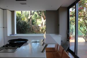 a kitchen with a stove and a window at Villa Calamocarro in Ceuta