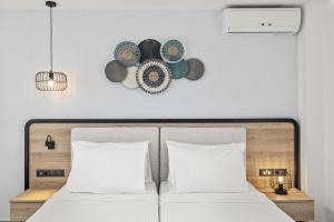 a bedroom with a bed and a clock on the wall at White Olive Marine Aquapark in Tigaki