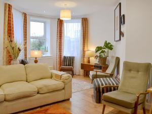 a living room with a couch and chairs at Retro Retreat in Filey