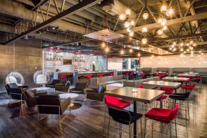 a restaurant with tables and chairs and a bar at Red Lion Hotel Kennewick Columbia Center in Kennewick