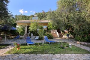 a group of blue chairs in front of a house at Rozalia Studios in Syvota