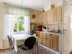 a kitchen with a table and chairs and a sink at Holiday Home Åkekvarn Snärjet by Interhome in Olofström