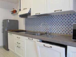 a kitchen with a sink and a refrigerator at Holiday Home Malva by Interhome in Bagni