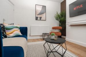 a living room with a blue couch and a table at New 4BedRoom Home - Near LFC & EFC in Liverpool
