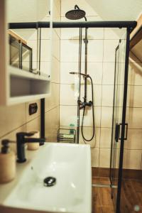 a bathroom with a shower and a white sink at Beskidzki Zakątek in Żabnica +14 photos