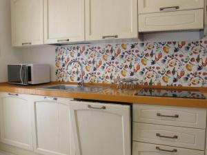 a kitchen with a sink and a patterned wall at Holiday Home Jolanda by Interhome in Bagni +23 photos
