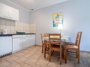 a kitchen with a dining room table and chairs at Holiday Home Domek Joanna-3 by Interhome in Łeba +10 photos
