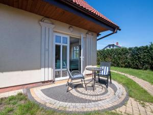 a patio with two chairs and a table at Holiday Home Domek Joanna-3 by Interhome in Łeba