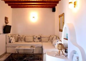 a living room with a couch and a table at Samanti Mykonos Sea View in Agios Ioannis Mykonos