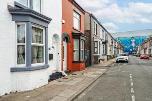 a street with buildings and a car parked on the street at New 4BedRoom Home - Near LFC & EFC in Liverpool