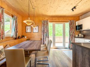 a kitchen and dining room with a wooden table and chairs at Chalet Klippitzperle by Interhome in Klippitztorl +67 photos