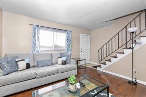 a living room with a couch and a staircase at Cozy 2 bedroom apartment in Dayton