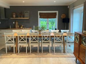 a dining room with a table and chairs at Enjoy Views In Helgeroa, Near The Beach in Helgeroa