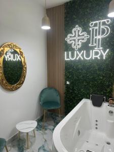 a bathroom with a tub and a mirror and a chair at Tp luxury in Naples +87 photos