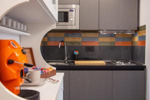 a kitchen with a sink and an orange bulldozer at vesuvius115 in Naples